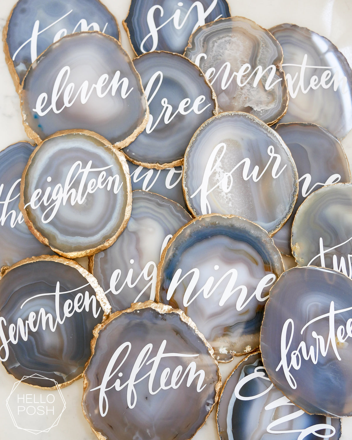 light gray agate with gold gilded rims and white text